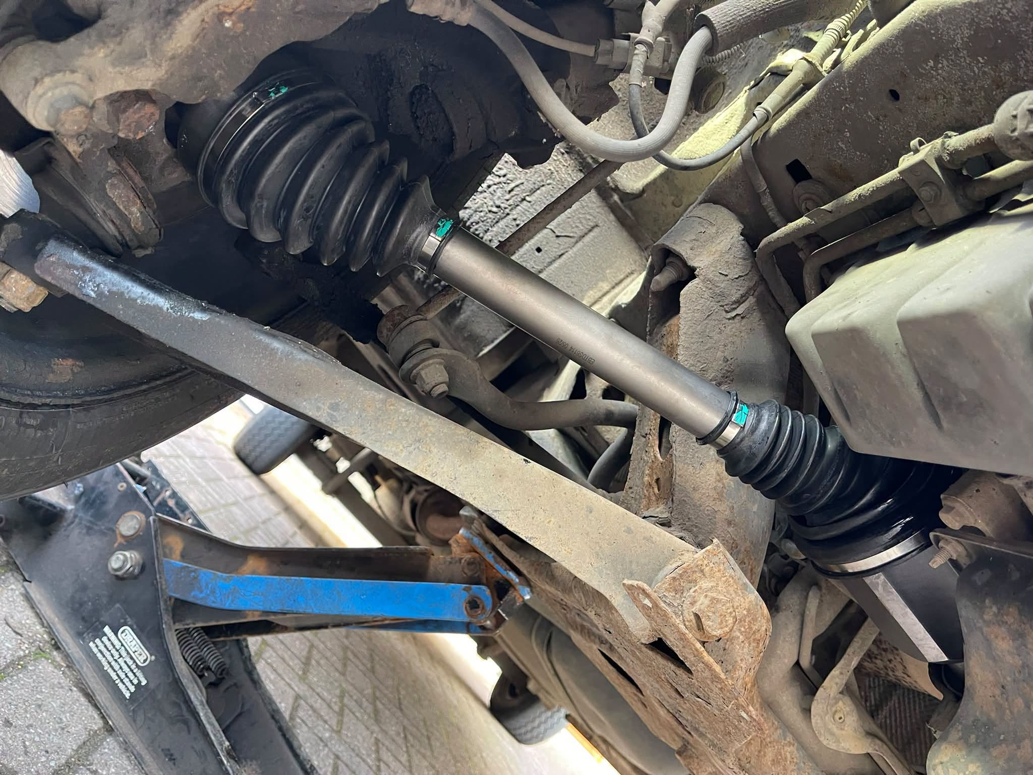 Underneath a car with a new drive shaft fitted