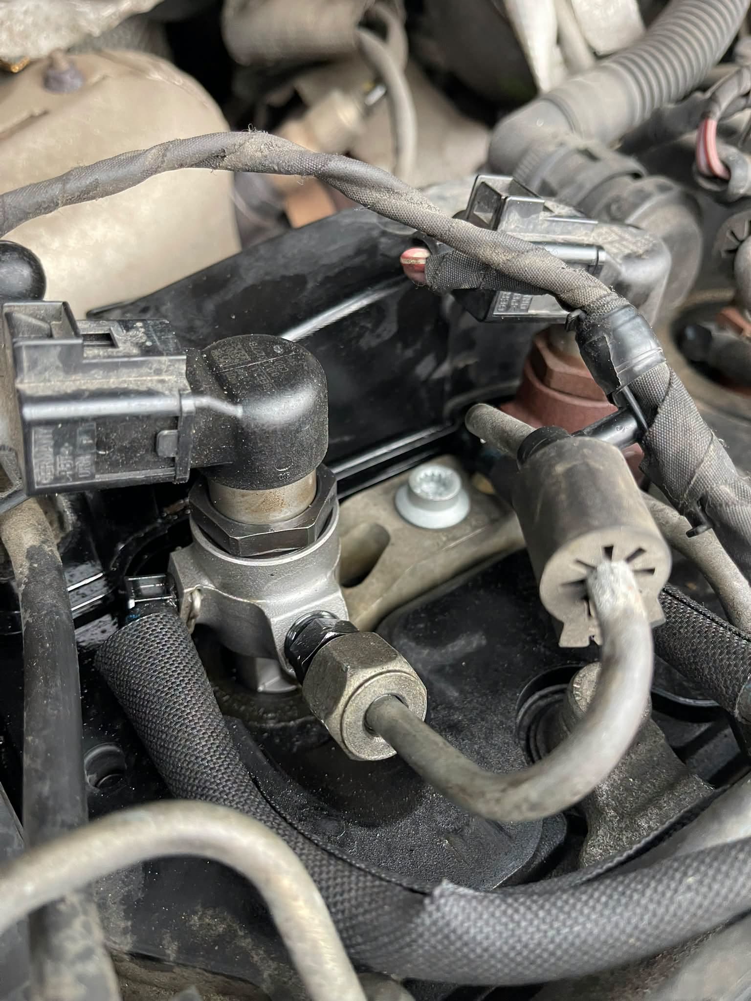 Under the bonnet of a diesel engine during an injector job